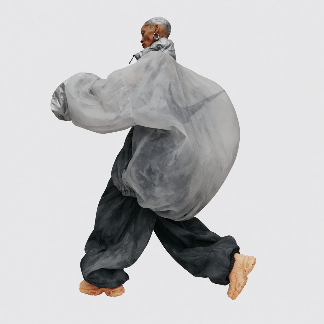 A figure in motion inside an inflated translucent gray jacket, with orange soles.