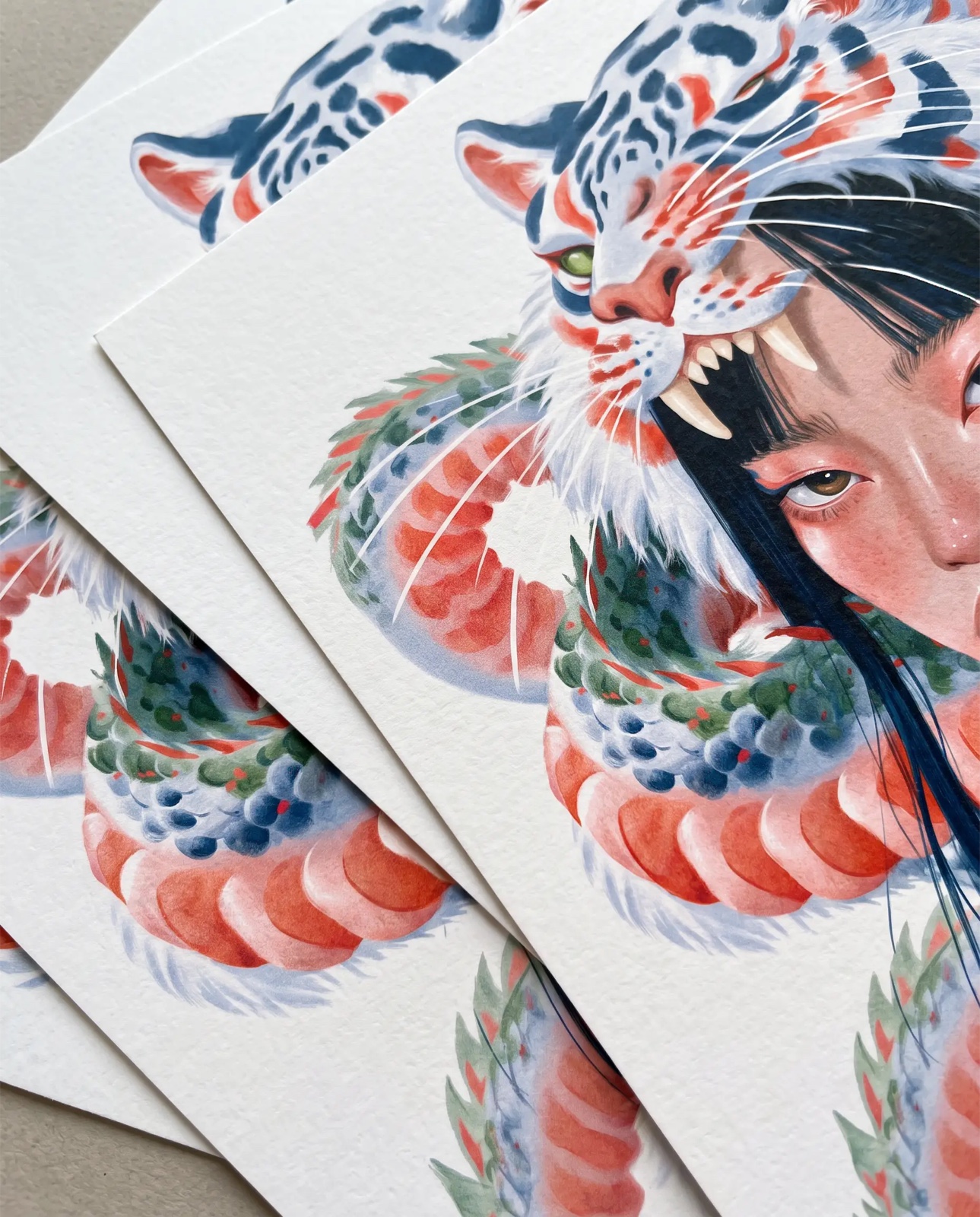 Close-up of the tiger and dragon artwork on textured paper.